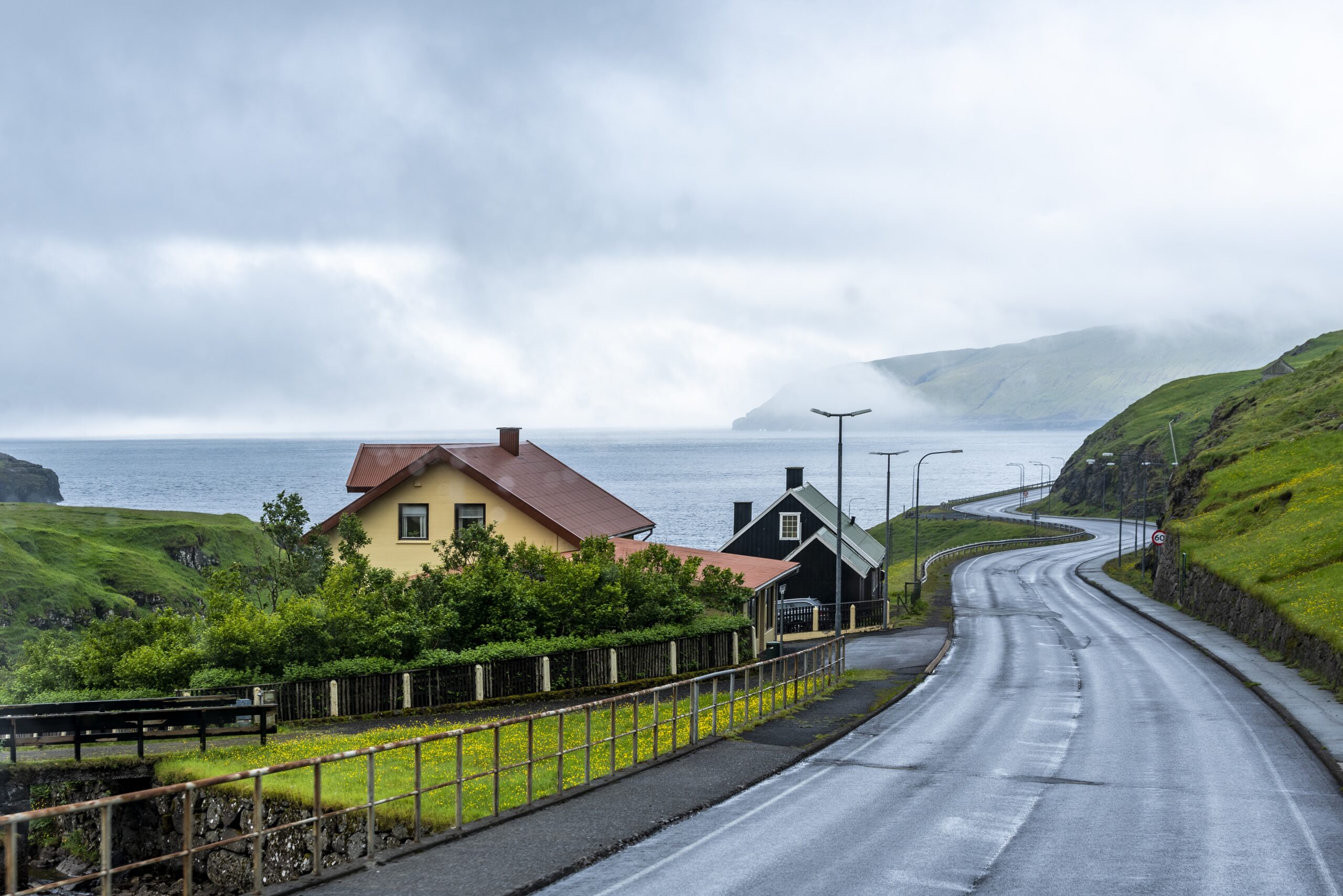 Empty street linking two islands together with the foggy sky