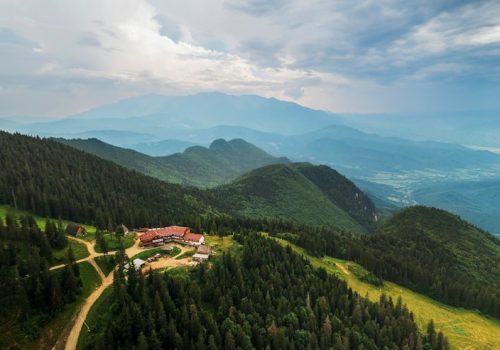 aerial-drone-view-poiana-brasov-romania-touristic-buildings-located-top-mountain-covered-with-lush-forest_1268-24836
