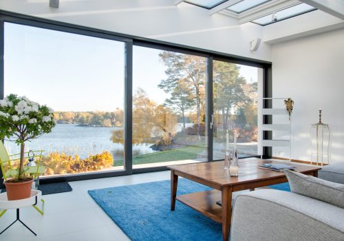 A beautiful view of a blue lake captured from the inside of a villa